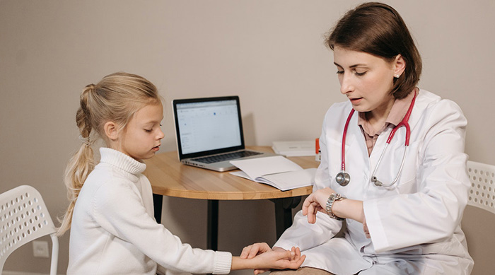 A girl getting a medical check from a female doctor