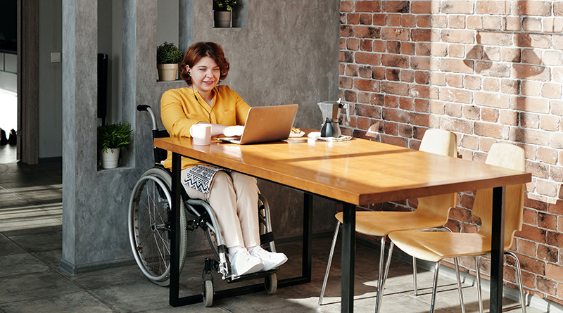 Woman in a wheelchair using a laptop